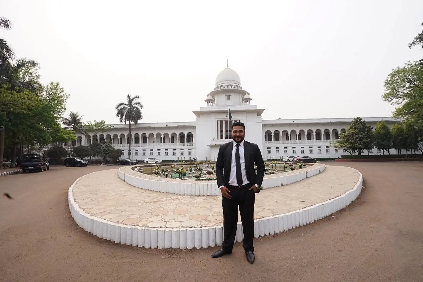 Cyrus standing in front of the Supreme Court of Bangladesh